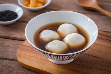 Glutinous rice balls filled with black sesame in sweet ginger soup