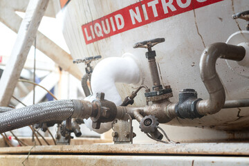 Close-up at pipeline and valve of the liquid nitrogen storage tank that operate in chemical and oil...