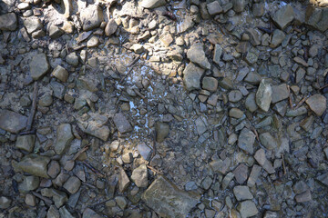 Background of shattered stony stones surface in mountain area. Texture with natural light