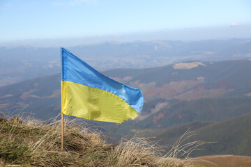 Ukrainian flag on top of Hoverla mountain in Ukraine