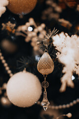 Crystal decoration and white Christmas ball hanging on the Christmas tree. Magic details. Winter holidays postcard