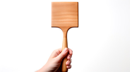 A close-up view captures a chef's hand holding a spatula, a signature tool in the kitchen, ready for culinary creations.
