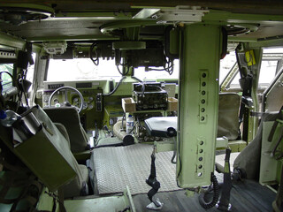 Military, army and interior of vehicle or transport for mission, training or battle with equipment or background. Transportation, van and inside for service, navigation or operation with armed forces