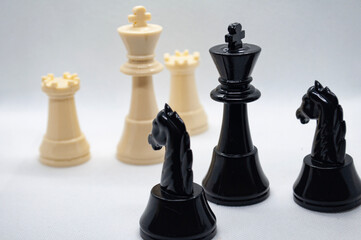 Chess game. Battle between black and white chess with white background. Strategy and battle concept
