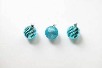 Three blue Christmas balls on a white background