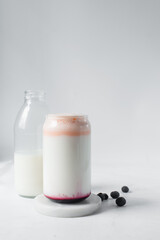 Peach and blueberry yogurt in a can shaped glass, peach blueberry yogurt in a glass shaped like a can, Aesthetic cafe ombre drink in a can glass