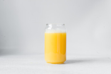 Orange juice in a can shaped glass, orange juice in a glass shaped like a can, Aesthetic cafe drink...