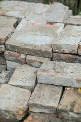 Solid clay brick used for construction, dark red brick. pile of bricks during the construction process.