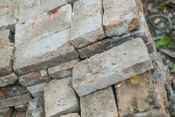 Solid clay brick used for construction, dark red brick. pile of bricks during the construction process.