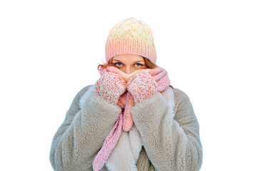 A smiling woman wraps herself in clothes warming up in a winter forest with trees in the snow,...