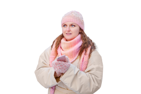 Happy woman with the phone stands alone in the winter forest near the , isolated on a white background. New Year in a park with snowy s
