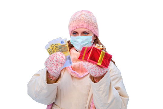 Young woman in face mask with new year gifts and money in euros near a snowy , isolated on a white background. Virus pandemic problem concept for new year.