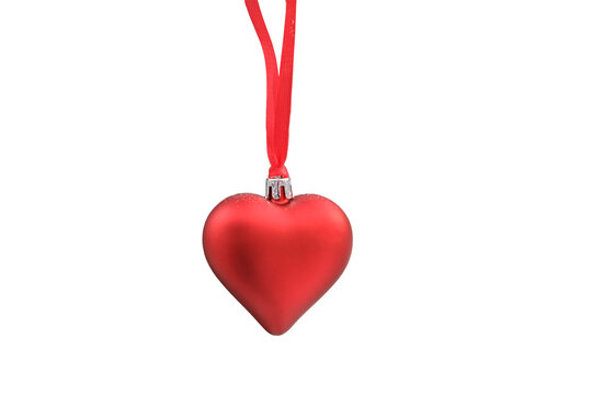 decorations in the form of red heart-shaped baubles hang on a snow-covered , isolated on a white background