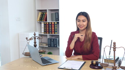 Portrait of a young female lawyer or lawyer working in an office. Smile and look at the camera.