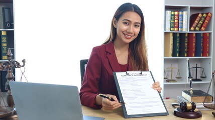 Portrait of a young female lawyer or lawyer working in an office. Smile and look at the camera.