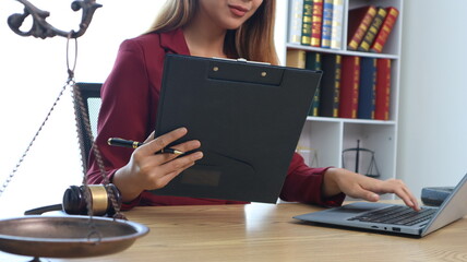 Portrait of a young female lawyer or lawyer working in an office. Smile and look at the camera.