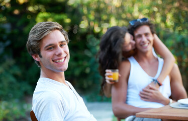 Man, portrait and friends in a backyard at home with bbq and happy event by a table. Group, teenager and young people together in a summer in a garden with a smile and food for lunch outdoor