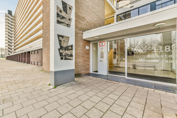 the outside of a building that has been painted with black and white designs on it's side, in front of an office