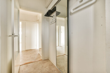 an empty room with a mirror hanging on the wall and two closet doors open to reveal a walk - in...