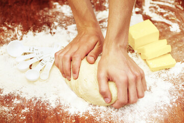 Hands, dough and butter, bakery and flour with production, food and baker person in kitchen with...