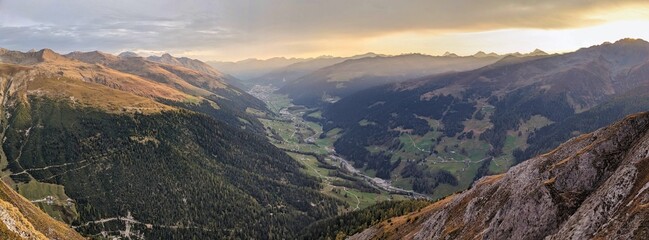 On the Alteingrat above Davos Glaris with a view of the Landwassertal valley and the mountain village of Davos. Sunrise in the Alps. High quality photo