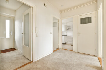 an empty room with white walls and door handles on the doors are closed to let in light into the room