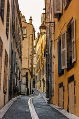Fototapeta na wymiar Clermont Ferrand, France - January 9 2023 - Narrow street in the medeival city of Clermont Ferrand