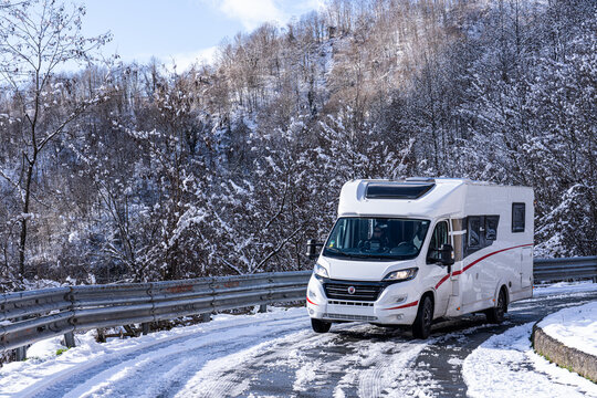 Campervan on a snowy road in Italy
