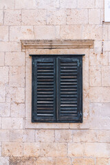 Old shutters in front of Medeival windows in the town of Dubrovnik, Croatia
