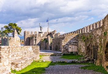 Nafpaktos, Greece - 4 february 2023 - The old city at the waterfront of the old venetian town with in the background the statue of Miguel de Cervantes Monument