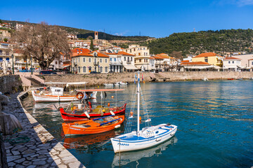 Fototapeta na wymiar Nafpaktos, Greece - 4 february 2023 - The old city at the waterfront of the old venetian town with a couple of boats in the harbour
