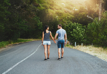 Road, travel or couple holding hands or walking on date with trust, care for romance, hiking or adventure. Loyalty, love or man with woman on holiday vacation together for bond, support or wellness