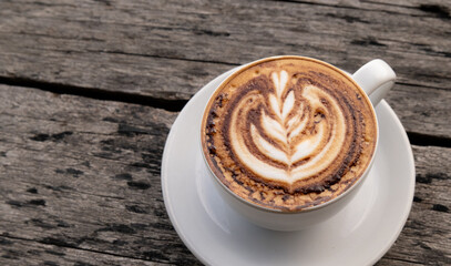 Coffee latte art on the old wooden surface