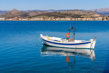 Empty fishing boats on the shore of the town of Nafplion on the Peninsula of Greece