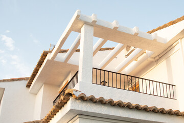 Specific spanish balcony and roof top. White mediterranean house balcony. 