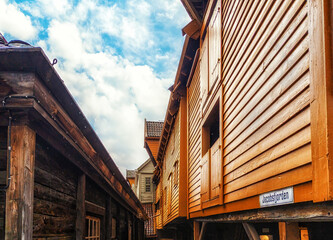 Hanseatic commercial wooden buildings on each side of passageway Bryggen Bergen Norway UNESCO world Heritage Site - obrazy, fototapety, plakaty