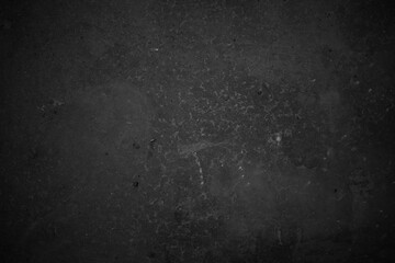 Textured black grunge background. Black concrete texture as a concept of horror and Halloween