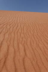 In the foreground, undulating striations of the Rub al Khali desert sand. Oman.