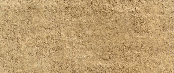 Clay wall of a clay house structure background. Brown clay mud grunge cement texture wall.