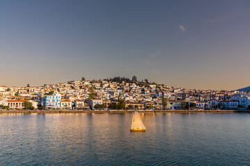 Poros, Greece - 17 February 2023 - View on the town of Poros on Poros island seen from the mainland at sunset