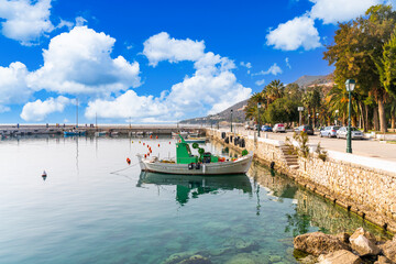 Loutraki, Greece - 1 March 2023 - harbour aith fishing boats en some cars in the small town of Loutraki - obrazy, fototapety, plakaty