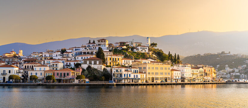 Poros, Greece - 17 February 2023 - View on the town of Poros on Poros island seen from the mainland at sunset