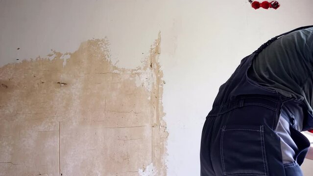 Applying finishing putty on the wall.