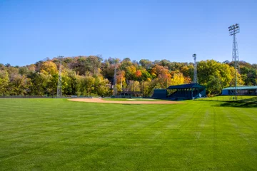 Fotobehang Fall colors on the hillside by Jordan Minnesota community baseball field © Rob Schultz