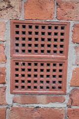 Brick wall with two ventilation bricks