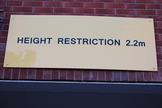 Yellow height restriction sign "Height restriction 2.2m"
