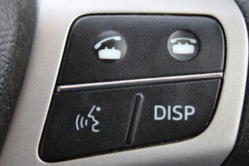Close up of a control panel from a car steering wheel, buttons to pickup and end a call
