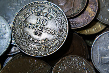 Honduras lempira coin on a pile of world coins