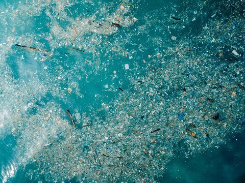 Ocean and plastic trash in Bali island. Aerial view of pollution by plastic rubbish in marina