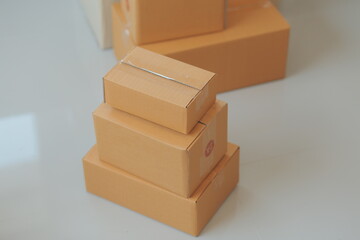 Startup SME small business entrepreneur of freelance Asian woman using a laptop with box Cheerful success Asian woman her hand lifts up online marketing packaging box and delivery SME idea concept